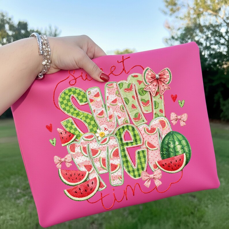 A watermelon applique design printed on a vibrant pink makeup bag, perfect for summer travel accessories