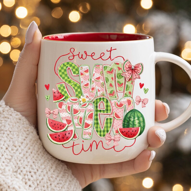A festive summer coffee mug with a red rim and handle, decorated with watermelon applique graphics