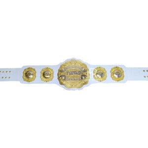May include: A white wrestling championship belt with gold accents. The center plate features the text "IWGP CHAMPION" in gold lettering. The belt has several gold medallions and a white strap with multiple holes for adjustment.