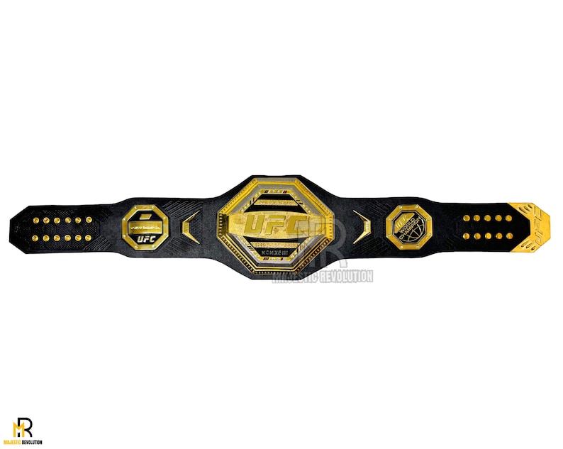 May include: A black leather UFC championship belt with gold accents. The belt features a large octagonal center plate with the UFC logo and the words "Ultimate Fighting Championship".