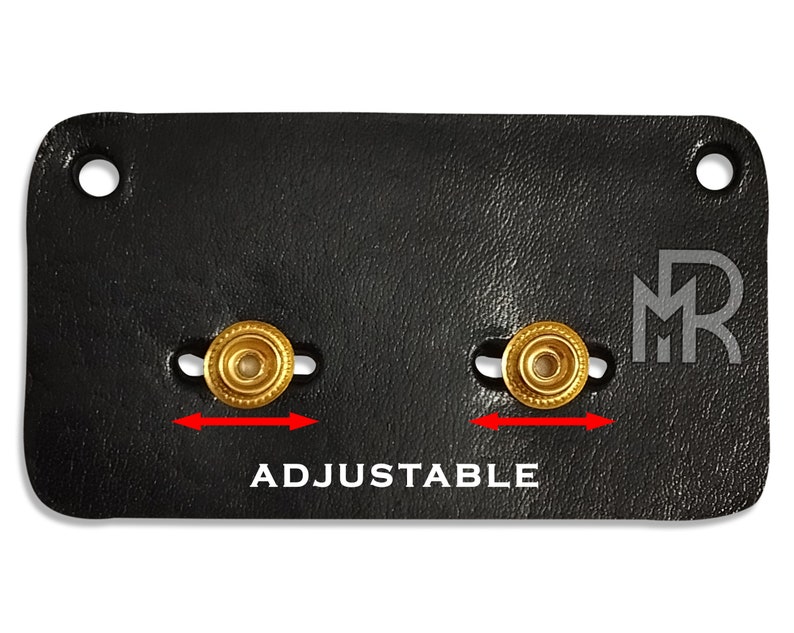 May include: Black leather adjustable strap with two gold metal buckles and the text "ADJUSTABLE" and the initials "MR" in white.