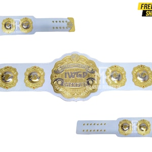 May include: White wrestling championship belt with gold accents. The belt features the text "INTERCONTINENTAL IWG CHAMPION" and several gold medallions. The image also includes the text "FREE SHIPPING".
