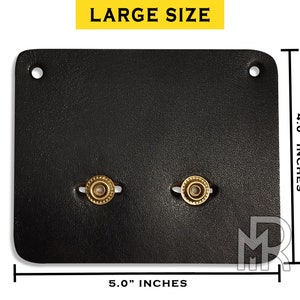 May include: Black leather wallet with two brass snaps. The wallet measures 5 inches wide by 4 inches tall.