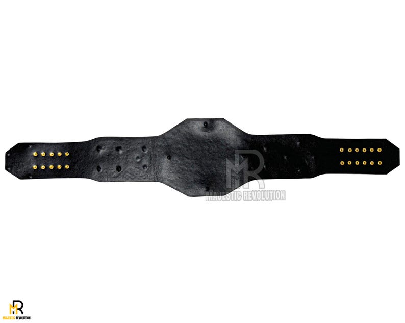 May include: Black leather wrestling championship belt with gold metal accents and rivets. The belt has two rows of gold rivets on each side.