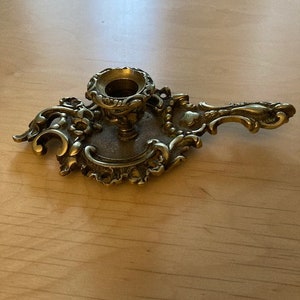 Antique cellar rat bronze hand candle holder