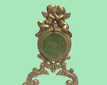 brass pocket watch case decorated with cherubs