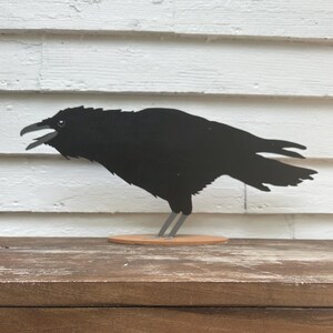 Life-size American Crow. Wooden bird handmade and hand-painted in New Hampshire.