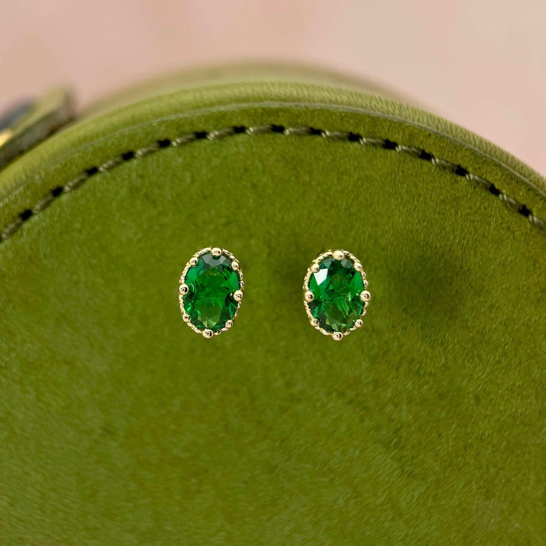 9K real gold with emerald green stones.