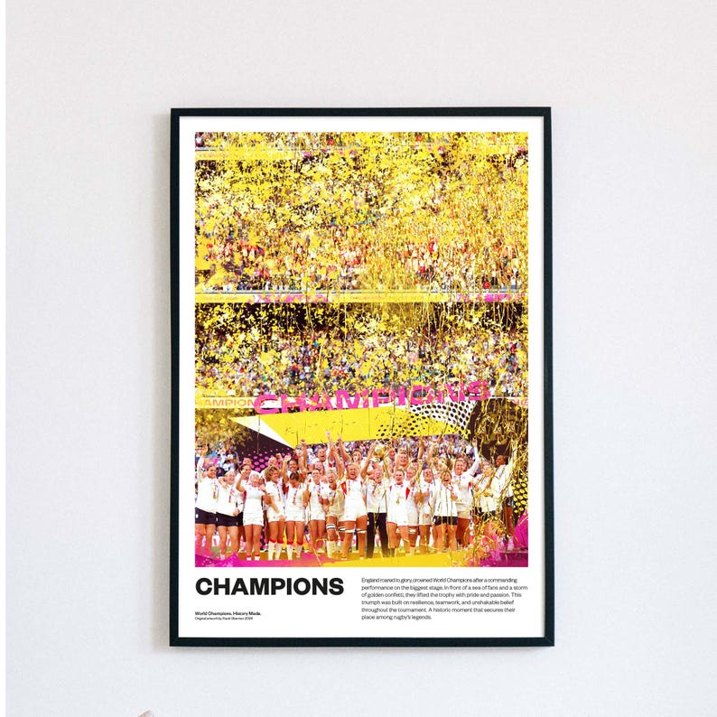 May include: A framed print featuring a celebratory image of a team in white uniforms holding a trophy, with yellow confetti falling from above. The word "CHAMPIONS" is prominently displayed in bold letters at the bottom of the image.