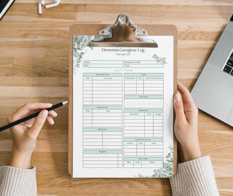 May include: A printable dementia caregiver log with sections for personal care, housework, bathing, supplies, medication, hydration, food, and social visits. The log is decorated with a green floral design.