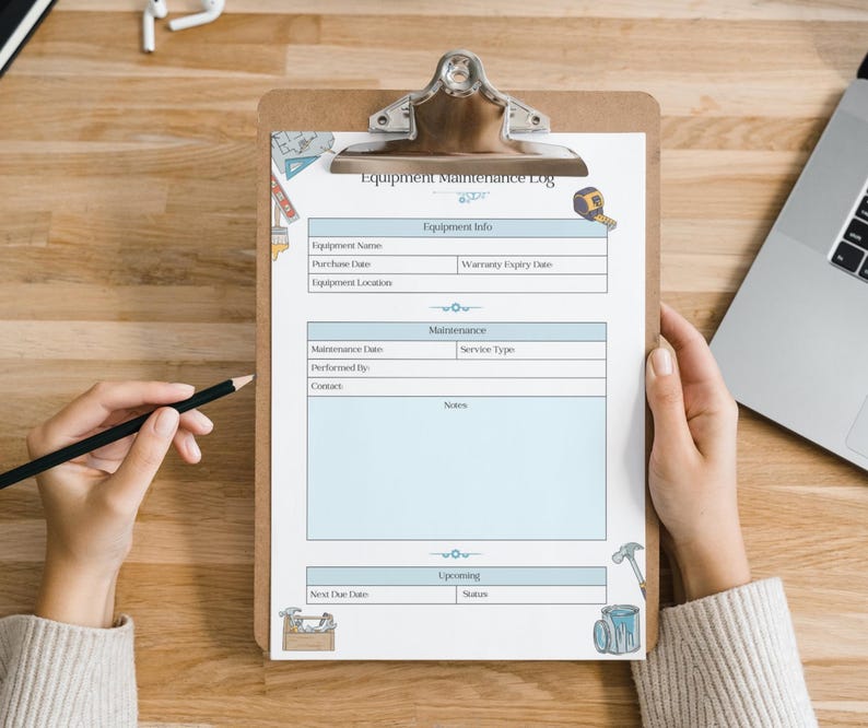 May include: A clipboard with an "Equipment Maintenance Log" form. The form has sections for equipment information, maintenance details, and upcoming tasks. A hand holds a pencil, ready to write on the form. The clipboard is on a wooden surface.