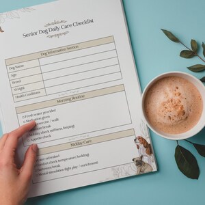 May include: A senior dog daily care checklist with sections for dog information and daily routines. A cup of coffee sits next to the checklist on a blue surface. The checklist includes illustrations of dogs.