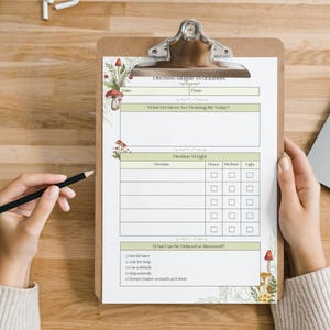 May include: A clipboard with a "Decision Fatigue Worksheet" printed on it. The worksheet has sections for time, decisions, and decision weight. The clipboard is decorated with mushroom and floral illustrations.