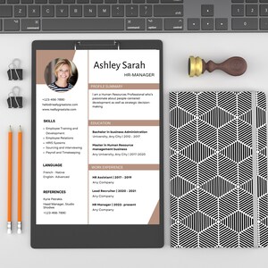 May include: A resume for Ashley Sarah, an HR Manager. The resume includes her contact information, skills, language proficiency, education, and work experience. The resume is on a brown background with a white border.