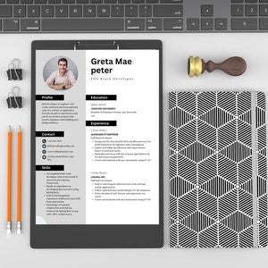 May include: A black and white resume on a clipboard with a photo of a person at the top. The resume is for Greta Mae Peter, a Full Stack Developer. The resume includes sections for profile, education, experience, contact, and skills.