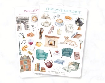 May include: Two sticker sheets with watercolor illustrations. One sheet features Parisian landmarks and pastries. The other sheet has cozy day elements like a fireplace, dog, books, and tea. The stickers are designed for planners and journals.