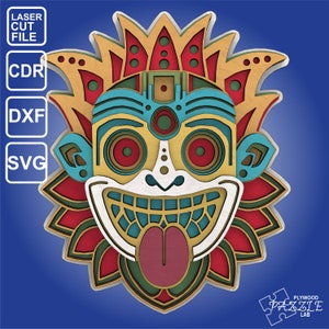 May include: A colorful, layered wooden mask with a smiling face, red eyes, and a large tongue sticking out. The mask has a floral design around the edges and is made of plywood.