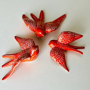 Red Portuguese Swallows with snow effect. Handmade, painted and glazed ceramic birds. Living art decorate your wall. Good as a gift for you.