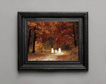 May include: A framed print of a fall forest scene with a path leading through the trees. Four white ghosts are walking down the path.