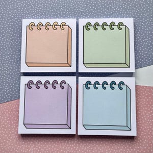 May include: Four square sticky notes with a spiral binding. The notes are in different colours: peach, light green, lavender, and light blue.