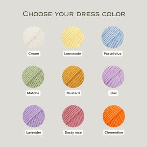 May include: Nine yarn colour options for a dress are displayed: cream, lemonade, pastel blue, matcha, mustard, lilac, lavender, dusty rose, and clementine. The text "CHOOSE YOUR DRESS COLOR" is at the top.