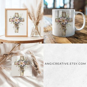 May include: A white ceramic mug with a floral design on a wooden cross. The cross is surrounded by white and pink flowers and green leaves. The mug is on a wooden table.