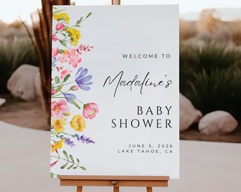 May include: A white welcome sign with a floral border and the text "Welcome to Madalines Baby Shower June 5, 2026 Lake Tahoe, CA".