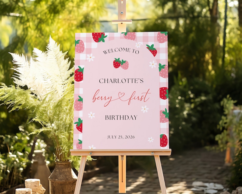 Berry 1st birthday printed sign is shown placed on an easel outside.