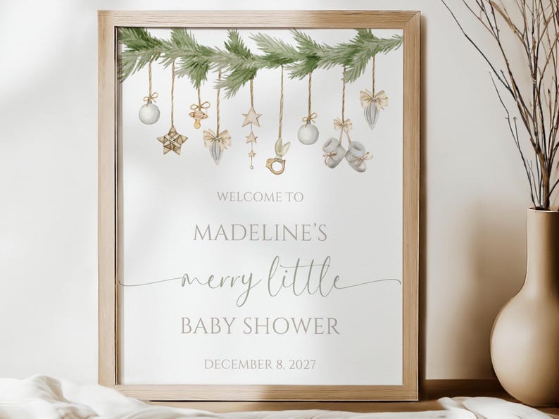 Christmas baby shower song is shown printed as the 16x20” size and placed in a frame and sitting on a table.