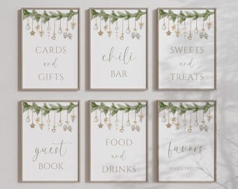May include: Six framed signs with text for a party or event. The signs have a white background with text in a script font. The signs are decorated with a green garland and hanging ornaments. The text on the signs includes "Cards and Gifts", "Chili Bar", "Sweets and Treats", "Guest Book", "Food and Drinks", and "Favours".
