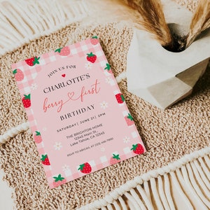 5x7” printed Strawberry 1st birthday invite shown laying flat.