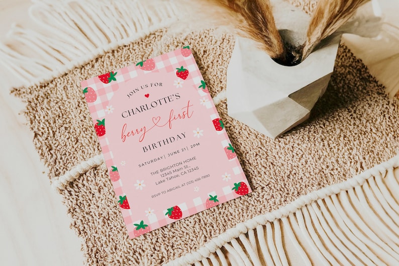 5x7” printed Strawberry 1st birthday invite shown laying flat.