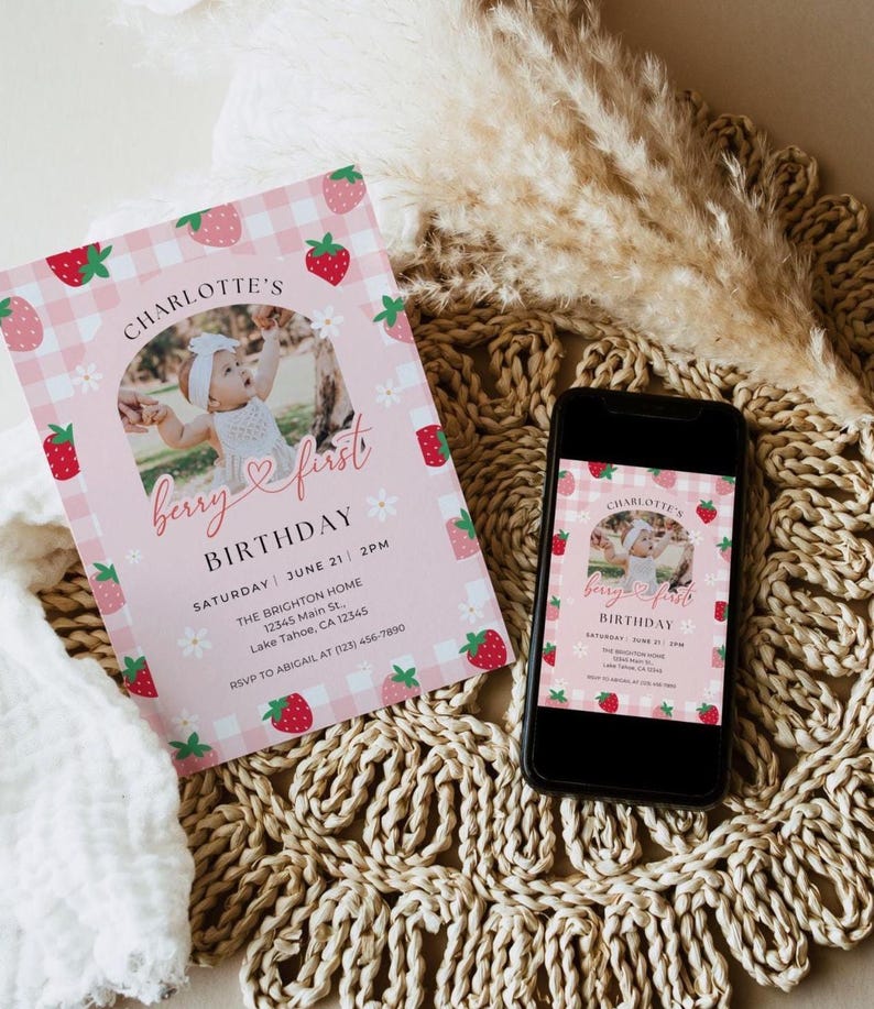 May include: Pink and white gingham birthday invitation with a strawberry pattern. The invitation features a photo of a baby girl and the text "Charlotte's Berry First Birthday" with the date and time of the party. RSVP information is included at the bottom.