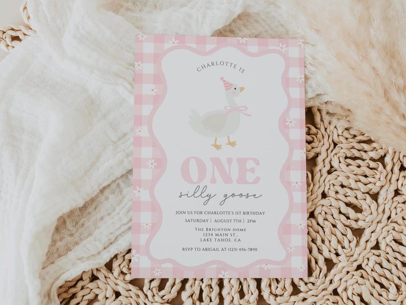 May include: A pink and white invitation card with a gingham border and a whimsical illustration of a goose wearing a party hat. The text reads "ONE silly goose" and includes event details. The card is on a neutral background.