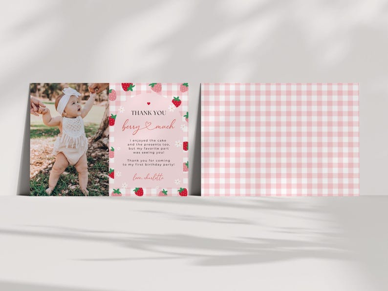 Strawberry first birthday thank you card shows the front and optional back side of the card. The back of the card is a pink gingham background.
