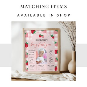 May include: A pink and white printable first birthday sign with a strawberry theme. The sign features a photo of a baby girl, along with details about her first year, including her nicknames, weight, height, and favorite foods. The text on the sign reads "Charlotte's Berry First Year".