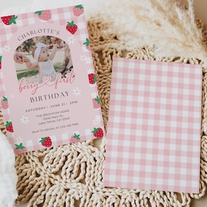 May include: Pink and white gingham patterned invitation with a photo of a baby girl in a white dress. The invitation says "Charlotte's Berry First Birthday" with the date and time of the party.