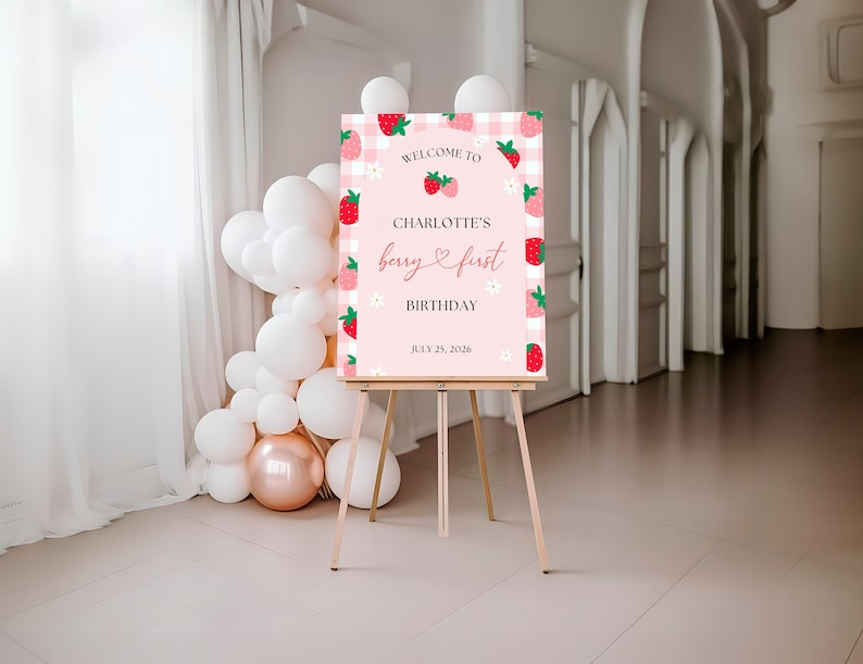 Berry First Birthday Welcome Sign has a space for the birthday girl’s name and the date of the event. Includes pink and red strawberries and white daises.