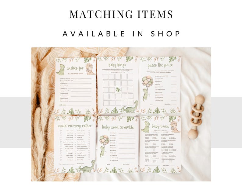 Op de afbeelding: Zes witte papieren spelkaarten voor een babyshower met groene dinosaurusillustraties en botanische accenten. De kaarten bevatten titels zoals Wishes for Baby, Baby Bingo, Guess the Price, Would Mommy Rather, Baby Word Scramble en Baby Trivia.