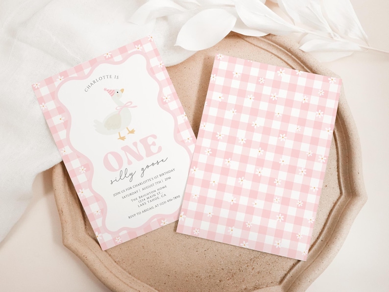 May include: Two pink and white invitations with a whimsical design. One features a cartoon goose wearing a party hat and the text "ONE silly goose." The other has a pink gingham pattern with small white flowers.