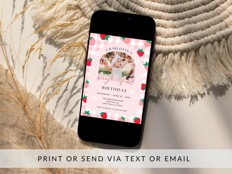 May include: A pink and white gingham patterned birthday invitation with a photo of a baby girl in a white dress. The invitation says "Charlotte's Berry & First Birthday" and includes the date, time, and location of the party.
