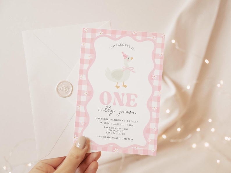May include: A pink and white invitation card with a gingham border and a cartoon goose wearing a party hat. The text reads "ONE silly goose" and includes event details. A white envelope with a wax seal is also visible.