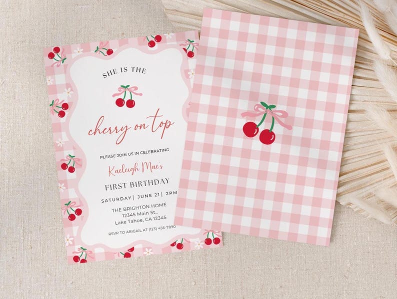 The front and back of the cherry birthday theme invitation is shown laying flat. the back of the invitation includes the pink and white gingham pattern with the red cherries with a pink bow in the center of the invitation.