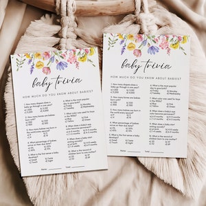 Two 5x7 baby trivia baby shower games shown laying flat.