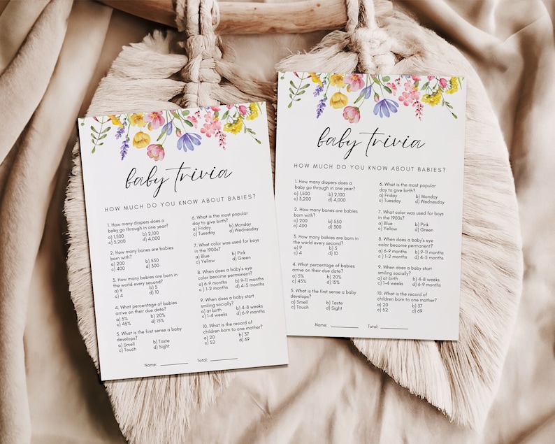 Two 5x7 baby trivia baby shower games shown laying flat.