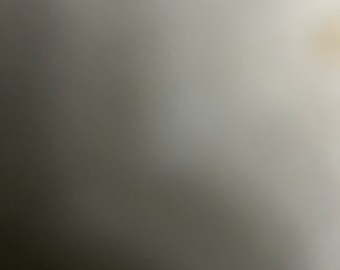 May include: A plain, off-white background with a slight gradient from light to dark.