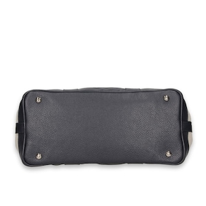Pu&ograve; includere: Una borsa grigio scuro con esterno in pelle strutturata. Il fondo della borsa presenta quattro piedini in metallo argentato. I lati della borsa hanno un design a righe nere e beige. La borsa &egrave; uno stile a manico superiore.