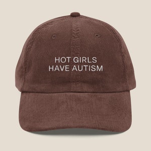 May include: A brown corduroy baseball cap with white embroidery that reads "HOT GIRLS HAVE AUTISM".