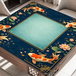 May include: Square wooden table with a dark blue surface featuring a koi fish and lotus flower design. The center has a light blue square. The table has a gold trim and decorative accents.