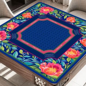 May include: A square mahjong table mat featuring a dark blue center with a geometric pattern, surrounded by a border of pink peonies and green foliage. The mat includes pink text labels for game directions like Play Right and Walls Left.